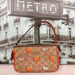 Coach CAL27 Nolita 19 In Signature Canvas With Orange Print